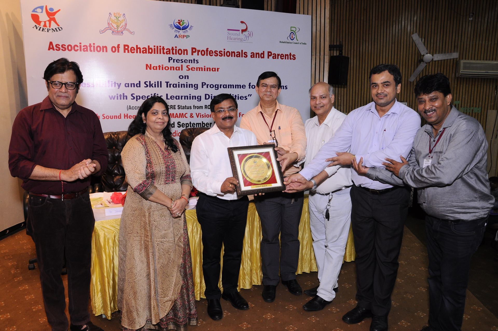 ARPP presents a National Seminar on Accessibility and Skill Training for persons with specific learning disabilities, with the chief guest being felicitated on stage.